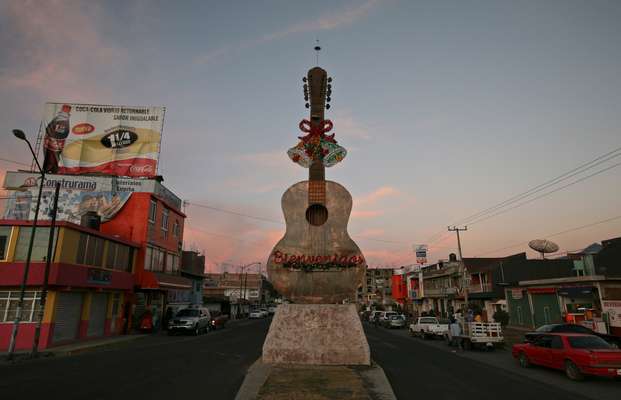 A giant copper statue of a guitar welcomes visitors to Paracho 