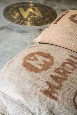 Raw cacao beans in bags that bear the Marou logo