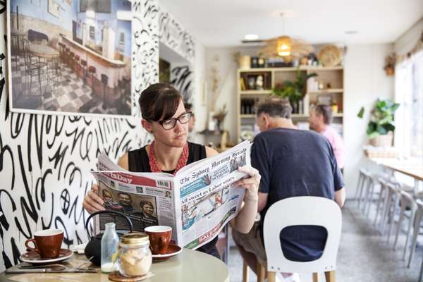 Reading the 'Herald' at the Fine Food Cafe