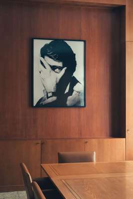 Oak-lined boardroom in Paris with a portrait of Saint Laurent