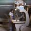 A carpenter uses an industrial saw at Roda yard