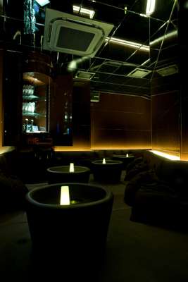 Room D has a black leather platform with circular tables, and mirrored walls and ceilings