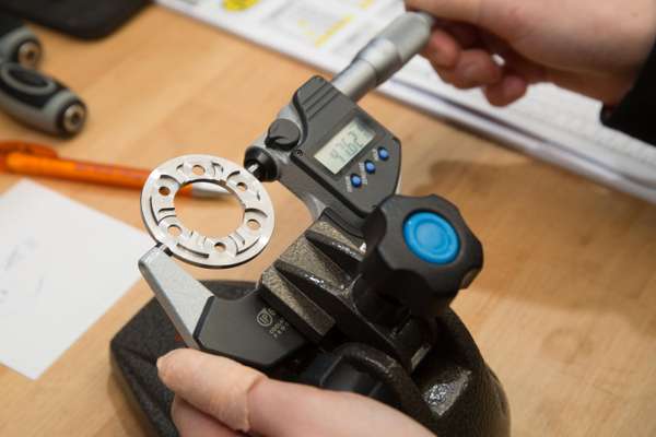 Kappstein employee measuring a product on a metal-cutting machine