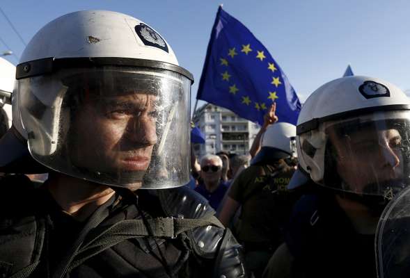 22 June 2015: Riot police standing between  anti-austerity and pro-EU protesters in Athens, Greece