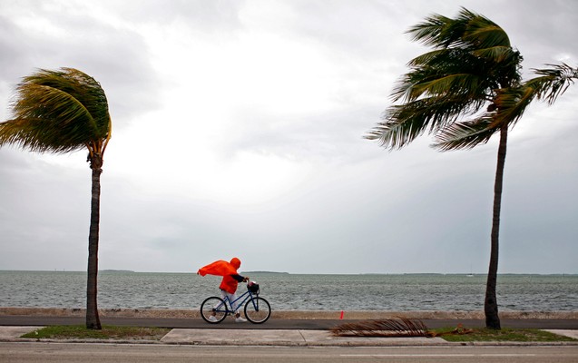 8 September 2008: woman walking her bicycle on an island in the Florida Keys during Hurricane Ike 