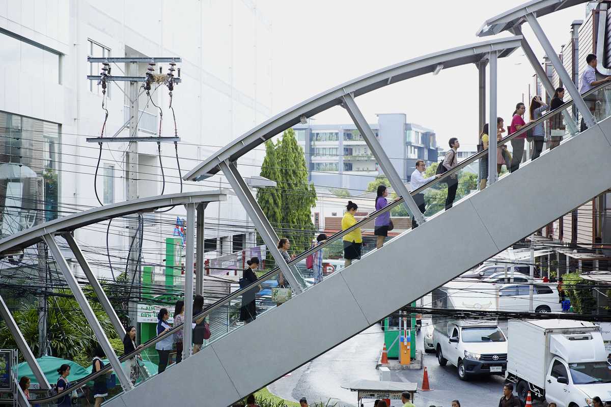Commuters ascend to Ari's Skytrain platform