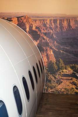 Mock aircraft soars above a mock Arizona