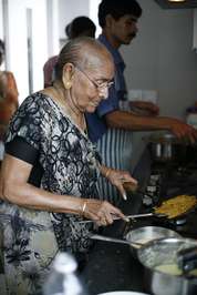 Gupta’s mother cooks in his kitchen 