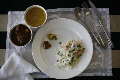 Plate of rice with a daal and lamb curry 