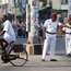 A Pondicherry policeman directs traffic wearing a French-style uniform, complete with kepi