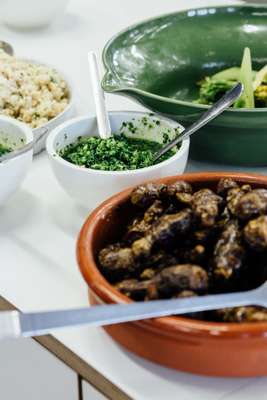 Dishes are distributed to each table and eaten buffet-style