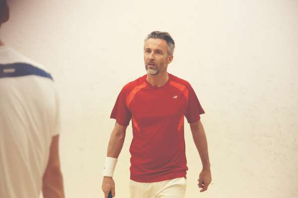  Ben wears red t-shirt by New Balance, shorts by Lotto, wristband and shoes by Nike, racquet by Wilson
