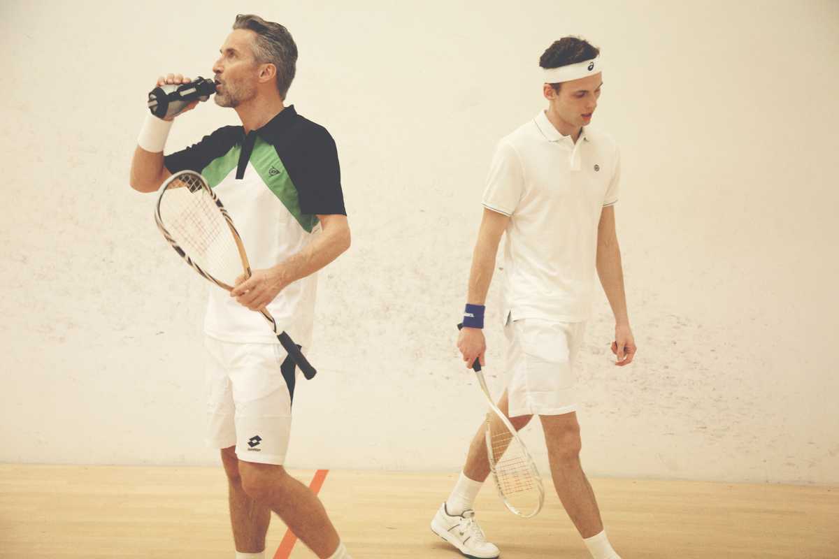Ben wears black, green and white t-shirt by Dunlop, shorts by Lotto, wristband and shoes by Nike, racquet by Wilson, drinks bottle by Asics. Chay wears white headband and blue wristband by Asics, polo shirt by Nike, shorts by Fred Perry, shoes and racquet by Wilson