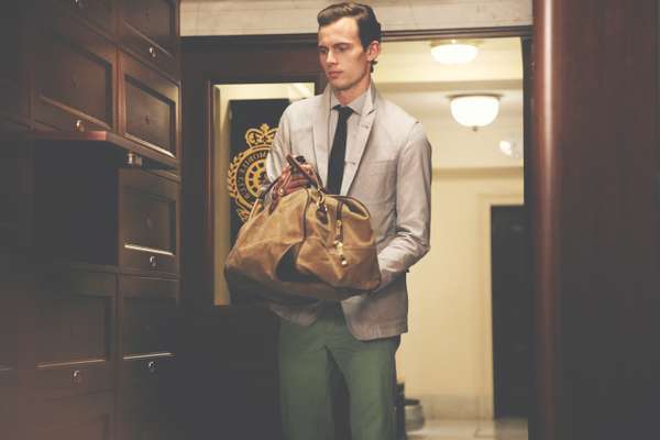 Chay wears jacket by Oliver Spencer, shirt and trousers by Hackett, tie by TS(S), bag by Woolrich John Rich & Bros