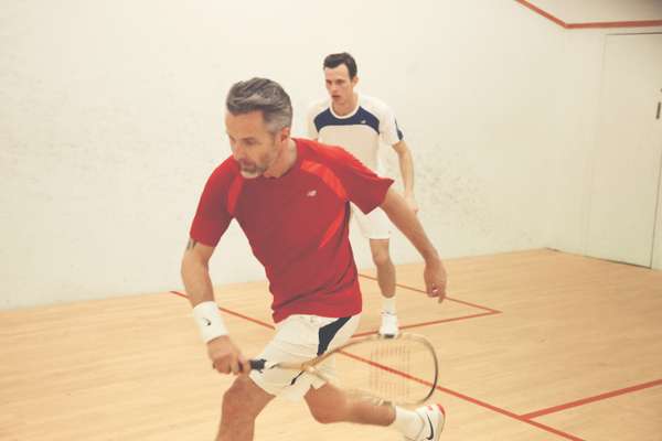  Ben wears red t-shirt by New Balance, shorts by Lotto, wristband and shoes by Nike, racquet by Wilson
