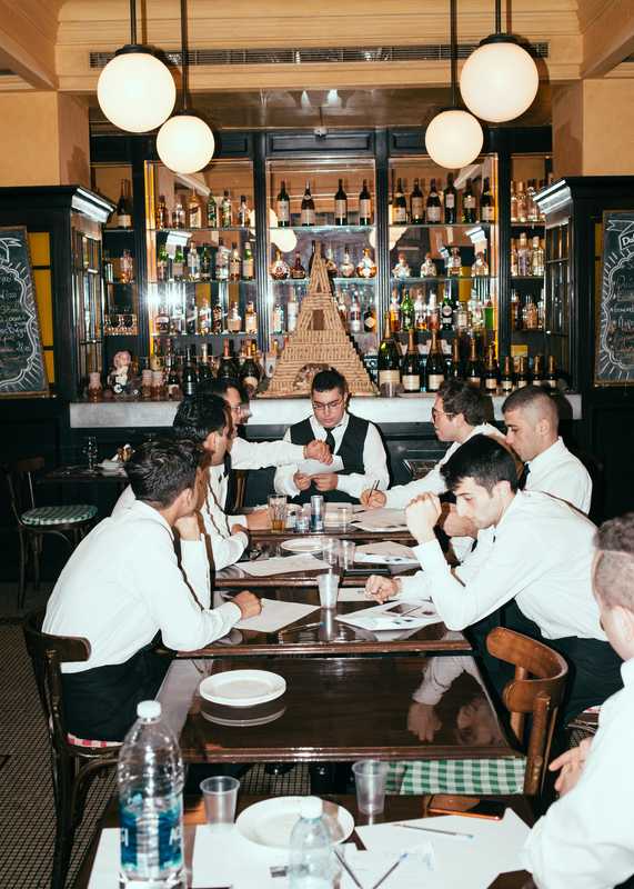Waiters waiting for the  evening’s service run to  begin in Gemmayze