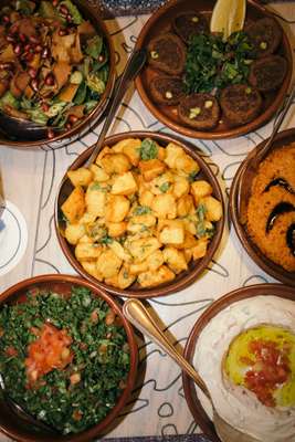 Mezze including fattoush, coriander potatoes and tabbouleh at Loris