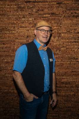 Attendee in front of a composite wall 