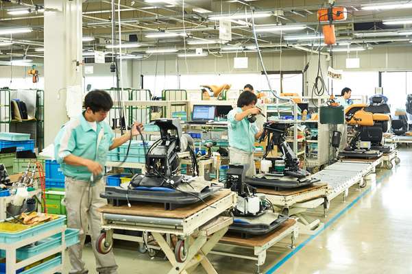 Workers assemble barber and salon chairs