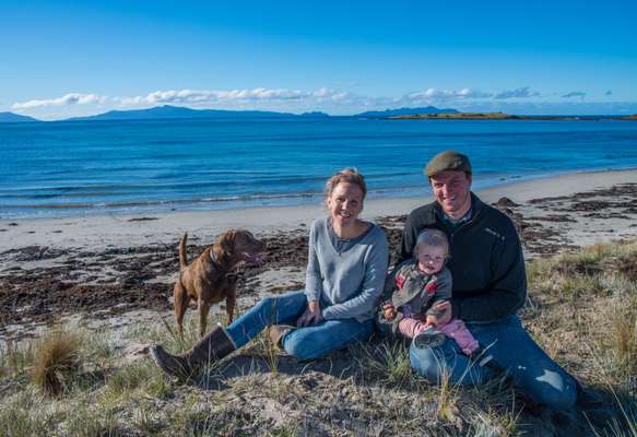 Producers Alice Laing and Chris Manson with daughter Flora and dog Beauly in Great Oyster Bay in Tasmania