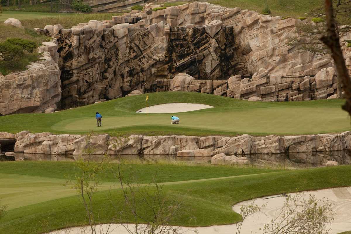 Course keepers check the green, Haesley