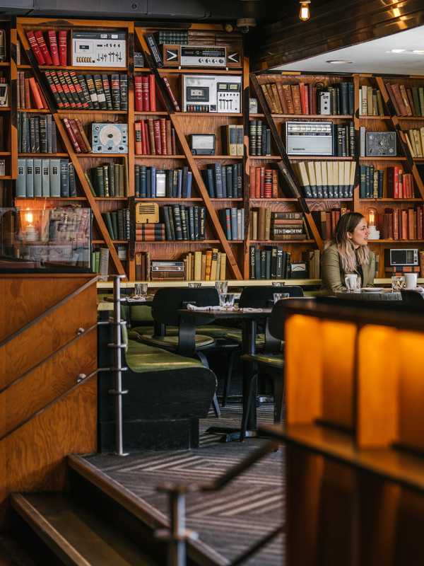 Books and vintage radios line the dining room walls