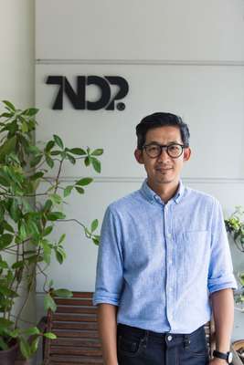 Tnop outside Tnop Design’s office  in Bangkok’s Bangkhen district