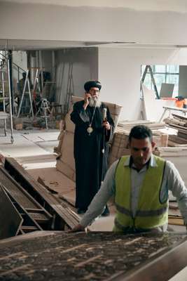 Bishop Suriel looks on as a panel is installed