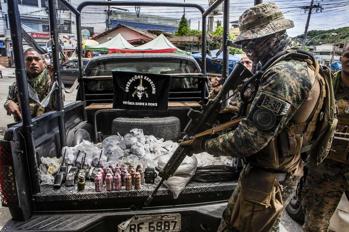 Police Special Operations troops reveal their haul – including drugs, radios and grenades – after an anti-trafficking operation.