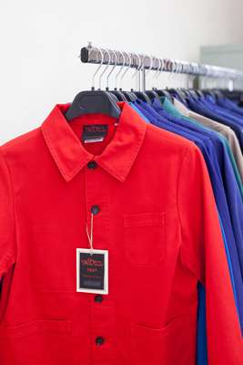 Pieces of clothing in bright colours and strong material, historically worn by workers