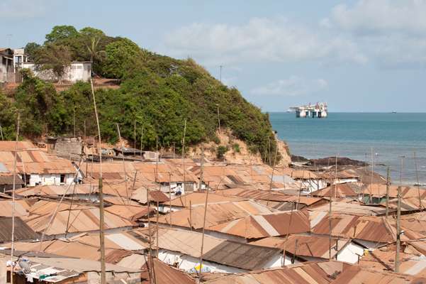 Roofs of Takoradi with view of off-shore oil rig 