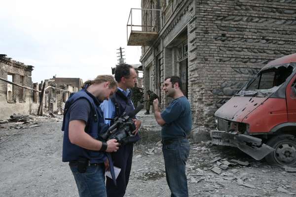 A Russian government official talks to an ITN crew after an attack on the old Jewish quarter in Tskhinvali