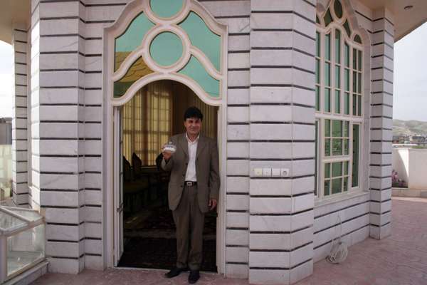 Faqiry holds the Pyrex sugar bowl that helped inspire the design of his house